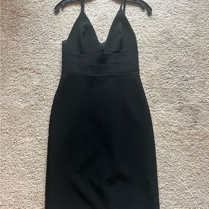 Alice and Olivia size 2 a deep V cut, beautiful black kneed length dress.